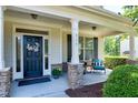 Cozy front porch with decorative columns, seating, and a welcoming entrance at 713 Liberty Cliff Dr, Cary, NC 27519