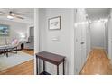 Neutral hallway featuring wood floors, a dark wood accent table and decor at 7918 Yester Ct, Raleigh, NC 27615