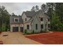 Two-story home boasts attached garage, manicured lawn, and neutral color palette at 7932 Wexford Waters Ln, Wake Forest, NC 27587