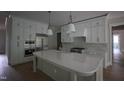 Bright kitchen features large island, white cabinets, and stainless steel appliances at 7932 Wexford Waters Ln, Wake Forest, NC 27587