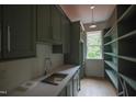 Mudroom with shelving, sink, and ample counter space and hardwood floors at 7932 Wexford Waters Ln, Wake Forest, NC 27587
