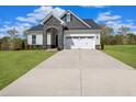 Charming two-story home with stone accents, attached two-car garage, and a well-maintained lawn at 87 Addison Pond Ct # 12, Zebulon, NC 27597