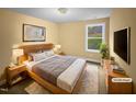 Staged bedroom with natural light featuring a queen-sized bed and matching nightstands on top of a neutral rug at 8844 Forester Ln, Apex, NC 27539