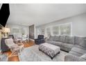 Open living room featuring hardwood floors, large windows, and stylish furniture at 903 S 2Nd St, Smithfield, NC 27577