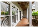 Private patio with brick flooring, windows, and outdoor access at 1000 Brighthurst Dr # 104, Raleigh, NC 27605