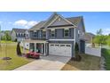 Charming two-story home with blue siding and manicured lawn and landscaping at 1002 Addington Lake Ln, Knightdale, NC 27545