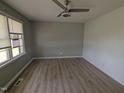 Bright bedroom featuring light gray walls, laminate wood flooring, and a ceiling fan at 1064 Abbott Rd, Henderson, NC 27537