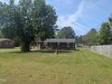 Traditional brick home with a well-manicured front lawn, showcasing curb appeal at 1064 Abbott Rd, Henderson, NC 27537