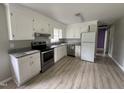 Clean kitchen with white cabinets, granite countertops, and stainless steel appliances at 1064 Abbott Rd, Henderson, NC 27537