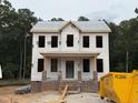 Under construction two-story home exterior featuring brick base and builder's wrap at 116 Legolas Ct, Middlesex, NC 27557
