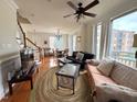 Open-concept living room boasts hardwood floors, large windows, and plenty of natural light at 1230 Capability Dr # 106, Raleigh, NC 27606