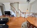 Spacious living area with hardwood floors, staircase, and access to multiple rooms at 1230 Capability Dr # 106, Raleigh, NC 27606
