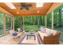 Relaxing screened porch featuring wood ceiling, skylights, comfortable seating, and serene backyard views at 12709 Timberlane Ct, Raleigh, NC 27613