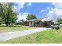 This ranch-style home has a covered parking area and well-maintained front yard, offering convenience and curb appeal at 1422 Duggins Dr, Burlington, NC 27217