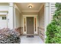 Inviting front porch featuring a brick foundation and a decorative welcome mat at 172 Token House Rd, Durham, NC 27703