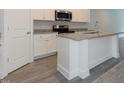 Contemporary kitchen featuring an island with granite countertops and stainless steel appliances at 1739 Old Fields Blvd, Haw River, NC 27258