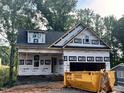View of new home under construction featuring a dumpster out front at 218 Oakdale Ave, Clayton, NC 27520