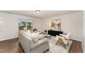 Bright living room with stylish seating and a chic media console at 2530 Girvan Dr, Fuquay Varina, NC 27526