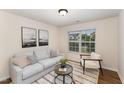 Inviting living room with neutral tones, a modern rug, and bright natural lighting at 2530 Girvan Dr, Fuquay Varina, NC 27526