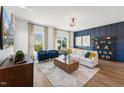 Open living space with a blue accent wall, stylish shelving, and hardwood flooring at 2810 Kempthorne Rd # 60, Cary, NC 27519