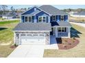 Beautiful new construction with blue siding, stone accents, and a two-car garage in a landscaped setting at 301 New Twin Br Ct, Smithfield, NC 27577