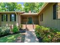 Inviting front entrance with brick steps and a covered porch with 'HOME' sign at 3216 Green Valley Dr, Sanford, NC 27330