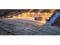 Outdoor living space with a custom patio, a built-in fire pit, and stone retaining wall at 400 Access Dr, Youngsville, NC 27596