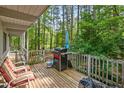 Cozy wooden deck with outdoor seating and a grill, perfect for enjoying the surrounding lush greenery at 4501 Zebulon Rd, Zebulon, NC 27597
