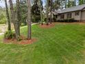 Landscaped front yard featuring trees and green grass in a residential neighborhood at 5109 Knaresborough Rd, Raleigh, NC 27612