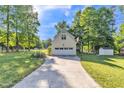 Detached garage with a basketball hoop and a long driveway, offering ample parking space at 540 W Juniper Ave, Wake Forest, NC 27587