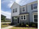 Charming townhome with light gray siding, black trim, and manicured front lawn at 6441 Granite Quarry Dr, Raleigh, NC 27610