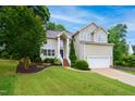 Traditional two-story home with lush landscaping, a manicured lawn, and a welcoming front entrance at 802 Windermere Lake Ct, Apex, NC 27502