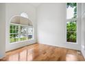 Bright living room features hardwood floors, high ceilings, and large windows that let in plenty of natural light at 802 Windermere Lake Ct, Apex, NC 27502