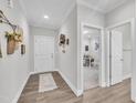 Bright entryway featuring hardwood floors, white walls and trim, and views into the office at 9 Little Sunshine Brk, Smithfield, NC 27577