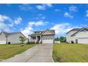 Well-maintained home with a two-car garage and landscaped front yard on a sunny day at 9 Little Sunshine Brk, Smithfield, NC 27577