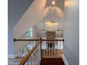 Bright living room featuring a stone fireplace, hardwood floors, and large windows at 90021 Hoey, Chapel Hill, NC 27517