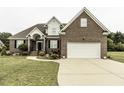 Charming brick home with an attached garage and a curved walkway to the front door at 9123 Thomas Rd, Rocky Mount, NC 27803