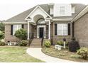 Charming front entrance with manicured landscaping and a brick facade at 9123 Thomas Rd, Rocky Mount, NC 27803