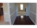 A view of the foyer featuring wood floors leading into a carpeted living area at 919 Middle Ground Ave, Rolesville, NC 27571