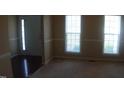 A carpeted room featuring a pair of large windows allowing natural light at 919 Middle Ground Ave, Rolesville, NC 27571