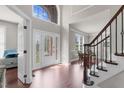 Bright foyer with hardwood floors, staircase and a decorative glass front door at 9639 Clubvalley Way, Raleigh, NC 27617