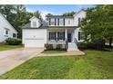 Charming two-story home with well-maintained lawn, two-car garage, black shutters, and front porch at 100 Citrus Pl, Cary, NC 27519