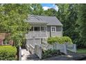 Charming condo with wood bridges leading to a covered porch entry and second story balcony at 101 Oyster Bay Ct # B2, Cary, NC 27513