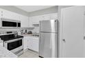 Clean kitchen includes stainless appliances, granite counters, and white cabinets at 101 Oyster Bay Ct # B2, Cary, NC 27513
