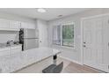 Eat-in kitchen offers stainless appliances and granite counters adjacent to entry door at 101 Oyster Bay Ct # B2, Cary, NC 27513