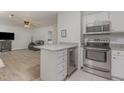 This spacious kitchen features stainless steel appliances, a granite countertop bar and ample lighting at 101 Oyster Bay Ct # B2, Cary, NC 27513