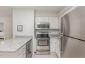 This kitchen features stainless steel appliances, subway tile, granite countertops and lots of lighting at 101 Oyster Bay Ct # B2, Cary, NC 27513