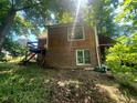 A view of the house from the back yard, highlighting a brick foundation at 103 N Woods Rd, Henderson, NC 27536