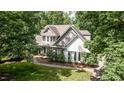 Beautifully landscaped home exterior surrounded by mature trees offering shade and privacy at 108 Ellsworth Pl, Chapel Hill, NC 27516