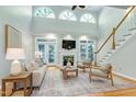 Bright living room with hardwood floors, fireplace, large windows, and staircase at 108 Ellsworth Pl, Chapel Hill, NC 27516